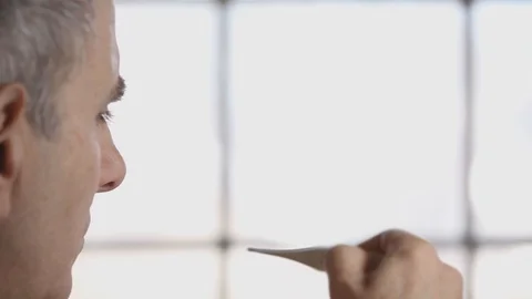 Senior Man Taking Temperature with Digital Thermometer Stock Footage 103697933