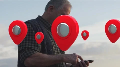 Senior man tapping smartphone by sea, checking locations, map tech showing red Stock Footage 335283060