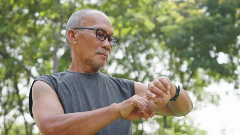 Senior Man with Tattoo Checking Time on smartwatch Outdoors Stock Footage 272217696