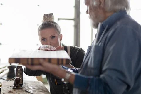 Senior man teaching apprentice in carpentry workshop Stock Photos
