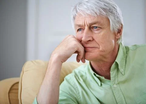 Senior man, thinking and reflection on sofa in home with ideas, memory and Foto stock