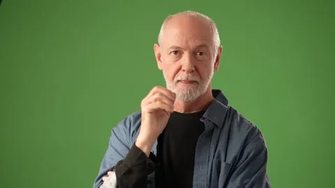 Senior Man With Thoughtful Expression Posing Against a Green Screen Background Stock Footage 305570168