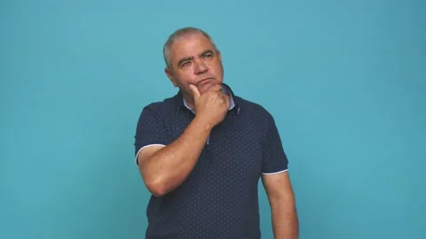 Senior man thoughtful looking to a copy space covering mouth with hand Stock Footage 144217556