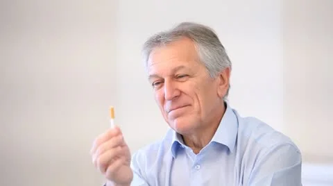 Senior man throwing cigarette away Stock Footage 14826499