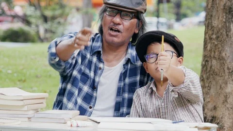 Senior Man training Boy about artist skill at park. Video stock 96117598
