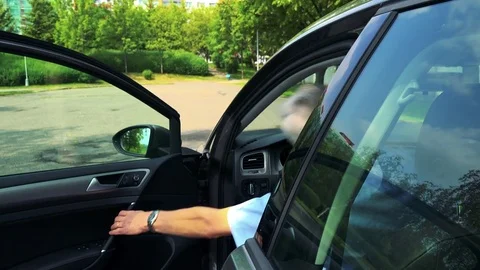 Senior man unlocks car with the key and gets in the car on the street with trees Stock-Footage 79155339