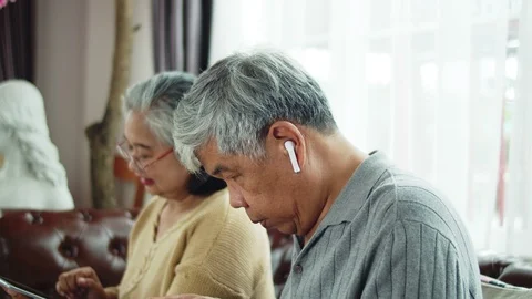 Senior man use wireless earphone to talking with telephone communication Stock Footage 118949941
