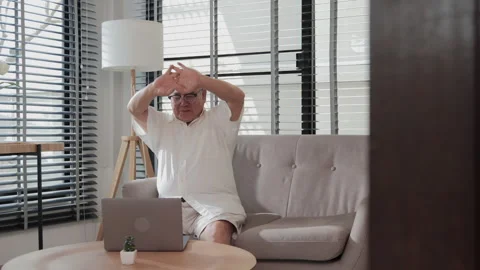 Senior man using computer at living room. Stock Footage 148678510