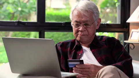 Senior man using credit card for online shopping Stock Footage 145675144