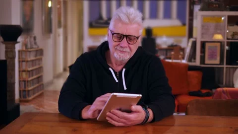 Senior man using digital tablet in living room Video stock 167362917