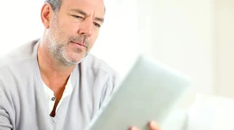 Senior man using electronic tablet Stock Footage 14829968
