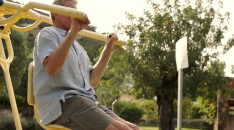 Senior man using exercise machine in park. Stock Footage 43674322