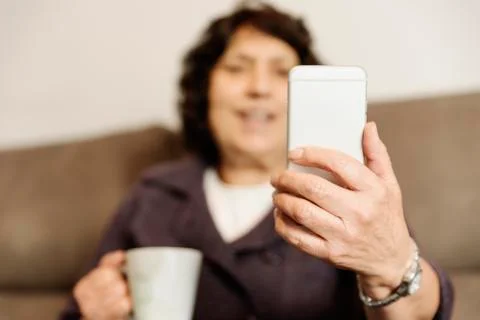 Senior man using her mobile phone. Stock Photos