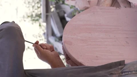 Senior man, using his craft skills, to carve the stone and shape Stock Footage 246340785