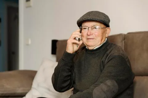 Senior man using his mobile phone. Stock Photos