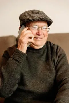 Senior man using his mobile phone. Stock Photos