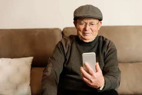 Senior man using his mobile phone. Stock Photos