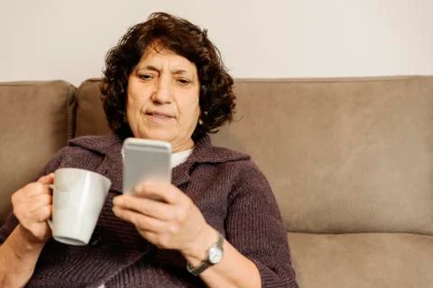 Senior man using his mobile phone. Stock Photos