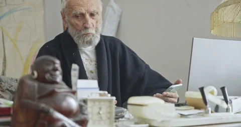Senior Man Using Laptop and Mobile Phone in Home Office in Morning Stock Footage 344348508