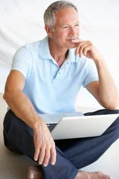 Senior man using laptop computer Stock Photos