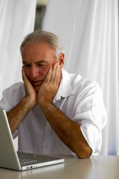 Senior man using laptop Stock Photos