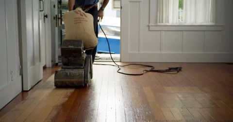 Senior man using a machine to sand a wooden floor. 스톡 동영상 88375570