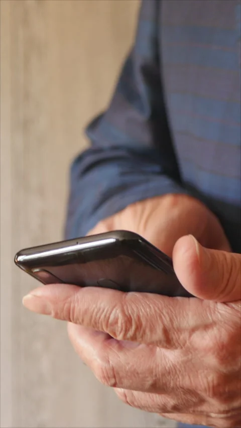 Senior Man Using Smartphone For Communication In Office. Vertical. Stock Footage 285794022