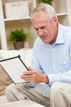 Senior man using tablet computer at home Stock Photos