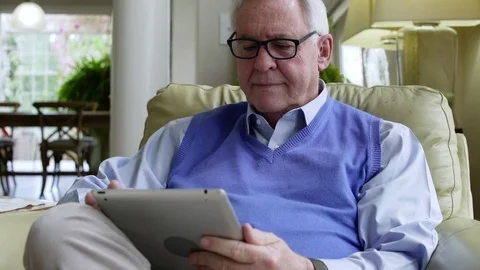 Senior man using a tablet at home Stock-Footage 83394482