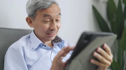 Senior man using tablet at living room. Stock Footage 220452078