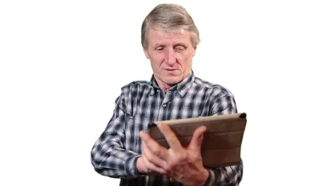 Senior man using tablet pc while standing on white isolated background Stock Footage 46428990