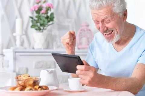 Senior man using tablet Stock Photos