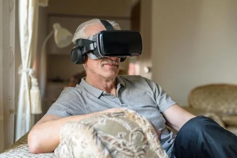 Senior man using VR glasses Fotos Stock