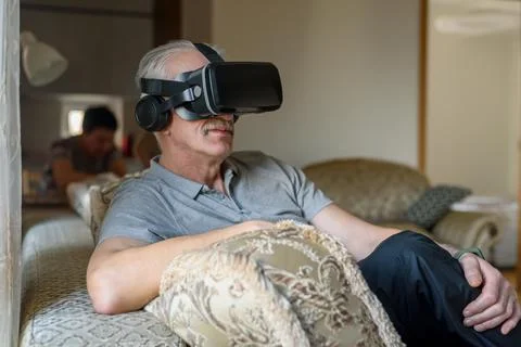 Senior man using VR glasses Stock Photos