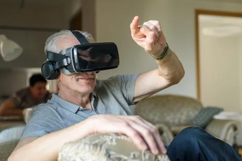 Senior man using VR glasses Stock Photos