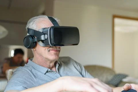 Senior man using VR glasses Stock Photos