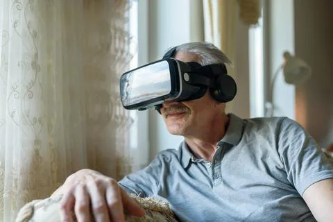Senior man using VR glasses Stock Photos