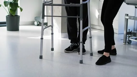 Senior man using a walker with the assistance of a nurse Stock Footage 197358425