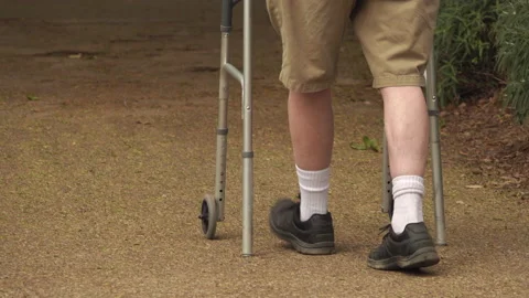 Senior man using a walker has trouble with uneven ground Stock Footage 153628672