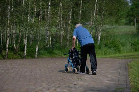 Senior Man Using Walker For Outdoor Mobility Support Stock Photos