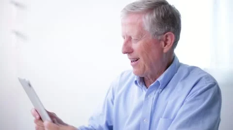 Senior Man Video Chats on Tablet Computer Stock Footage 20464168