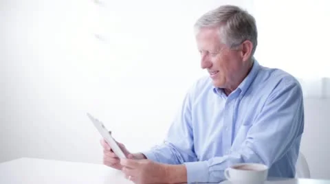 Senior Man Video Conferencing with Loved Ones on Tablet Computer Medium Shot Stock Footage 20464096