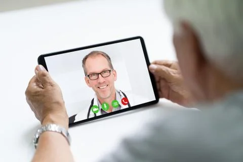 Senior Man In Videochat Or Videoconference With Doctor Stock Photos