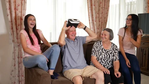 Senior man in virtual reality headset or 3d glasses having fun with family Stock-Footage 94105628