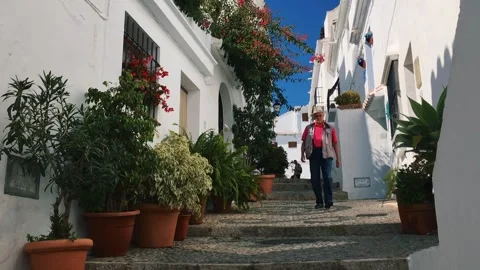 Senior man walking down the stairs in Frigiliana. Stock Footage 140472806