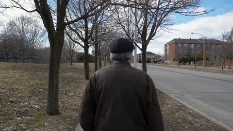 Senior Man Walking on The Sidewalk During Spring Stock Footage 74592517