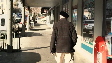 Senior man walking on a sidewalk. 스톡 동영상 88372487
