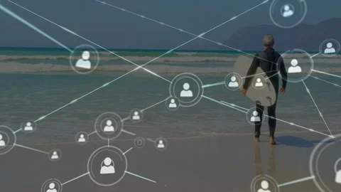 Senior man walking toward surf holding board, one node emerging and sparking Stock Footage 333873678