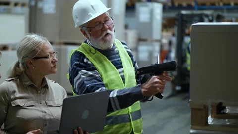 Senior man warehouse worker using bar code reader Video stock 166704282