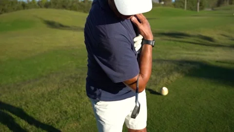 Senior man warming up for a round of golf. Hugs the club and performs upper.. Stock Footage 252603879